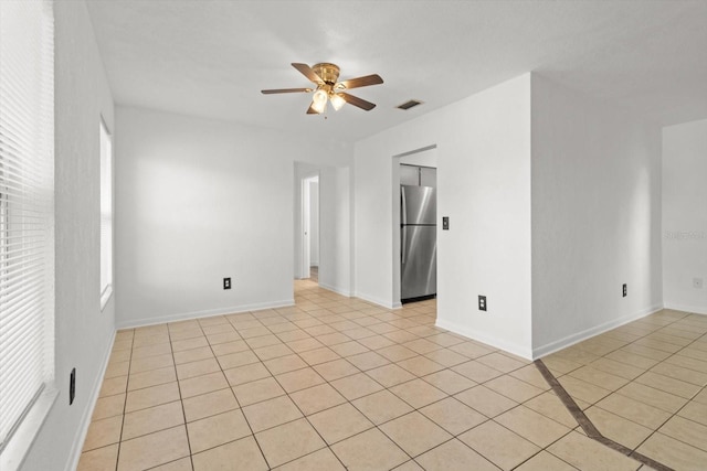 tiled empty room with ceiling fan