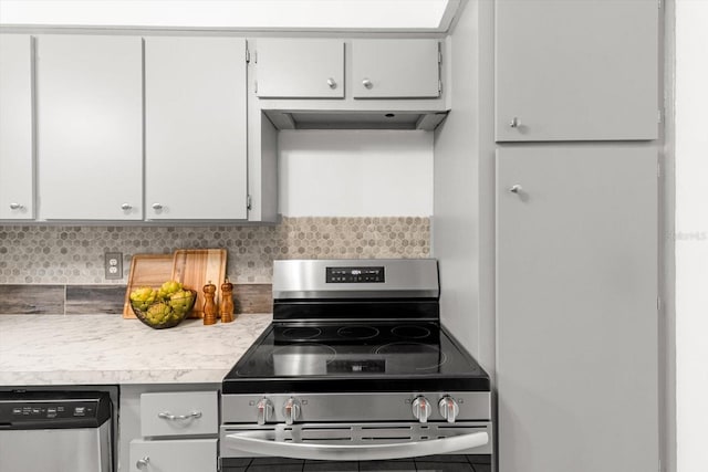 kitchen featuring tasteful backsplash, exhaust hood, white cabinets, and stainless steel appliances