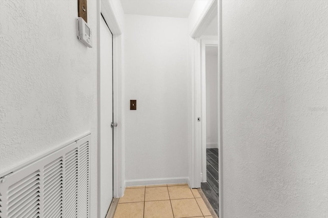 hallway with light tile patterned floors