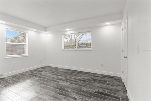 unfurnished room with dark hardwood / wood-style flooring