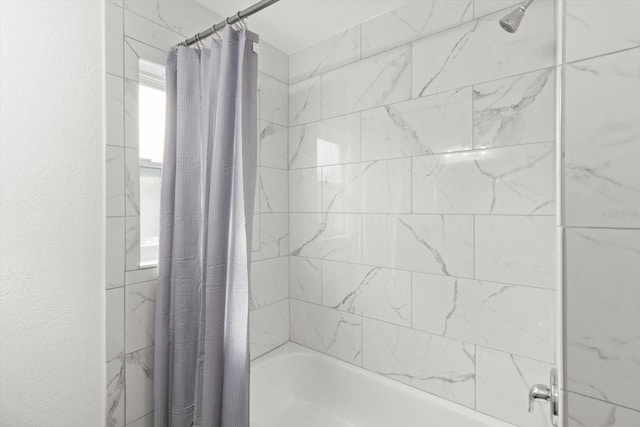 bathroom with shower / bath combination with curtain