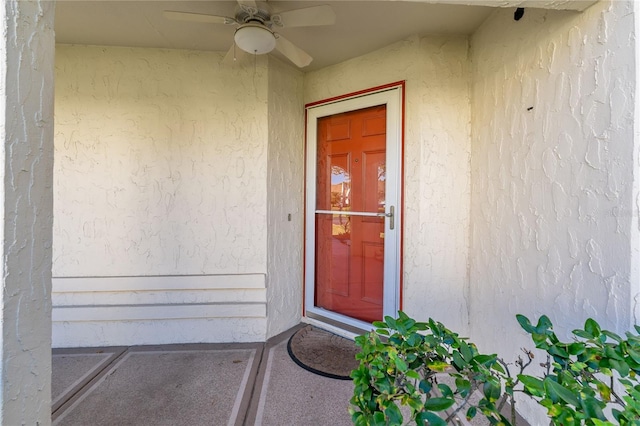 view of exterior entry featuring ceiling fan