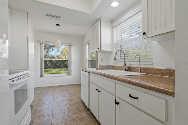 kitchen with white dishwasher, sink, range, white cabinetry, and hanging light fixtures