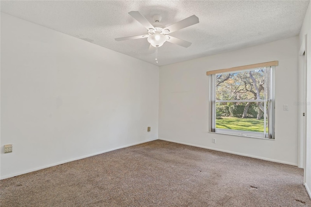 empty room with carpet flooring, a textured ceiling, and ceiling fan