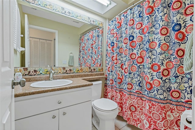 bathroom featuring tile patterned flooring, vanity, and toilet