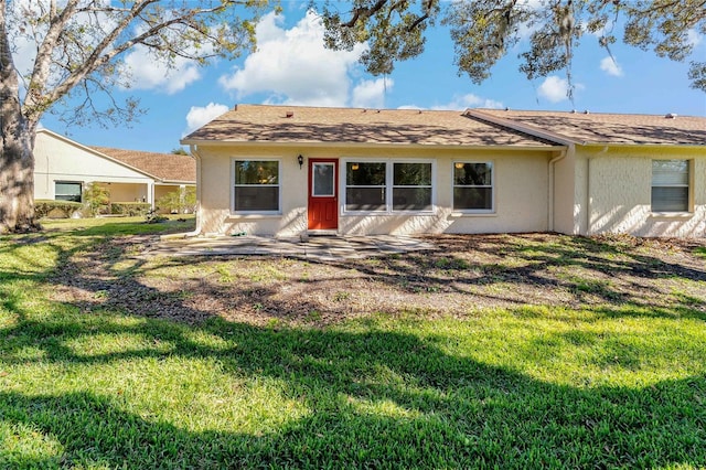 ranch-style home with a front lawn