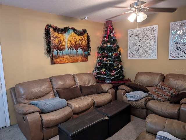 carpeted living room with ceiling fan