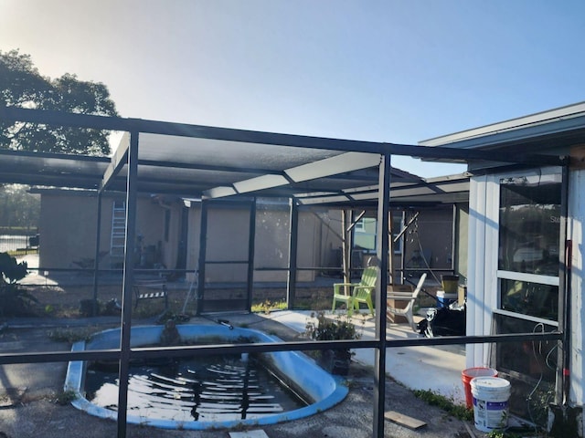 view of swimming pool featuring a lanai