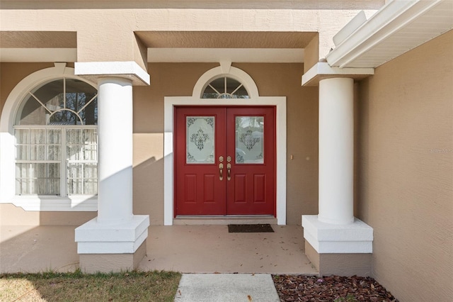 entrance to property with stucco siding