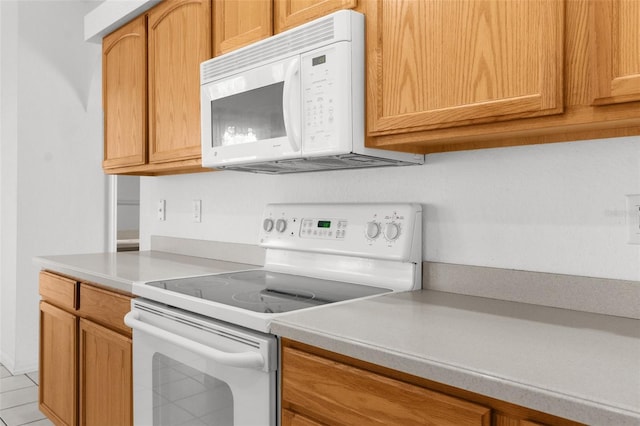 kitchen with light countertops and white appliances