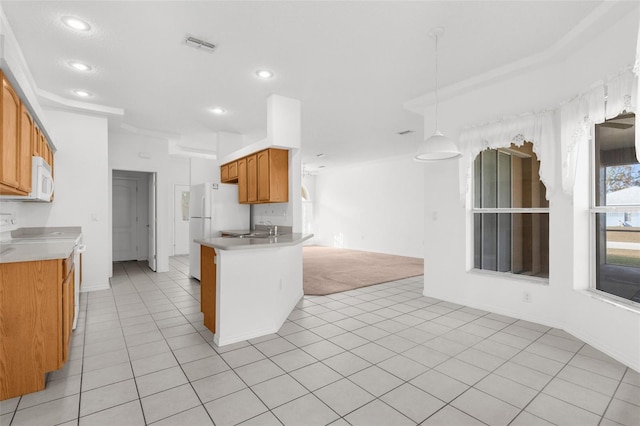 kitchen with sink, light tile patterned flooring, hanging light fixtures, and white appliances