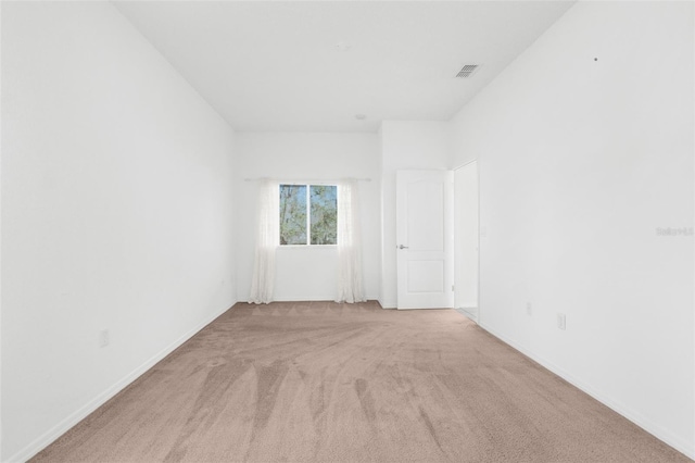 empty room featuring light colored carpet