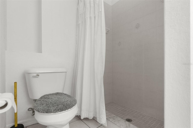 full bathroom with toilet, a stall shower, and tile patterned flooring