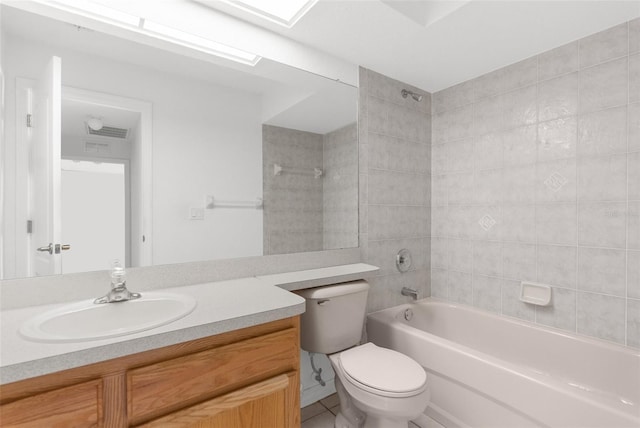 full bathroom with tiled shower / bath, tile patterned flooring, vanity, and toilet