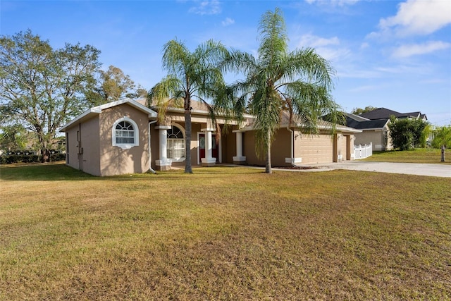 single story home with a garage, driveway, a front yard, and stucco siding