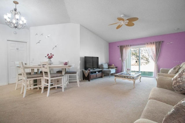 carpeted living room featuring ceiling fan with notable chandelier, a textured ceiling, and vaulted ceiling