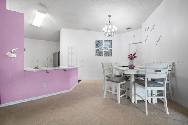 carpeted dining room featuring a textured ceiling, lofted ceiling, and a notable chandelier