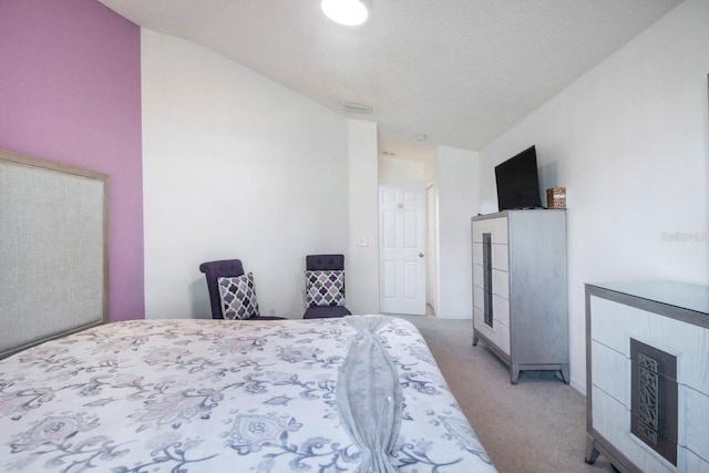 carpeted bedroom with vaulted ceiling