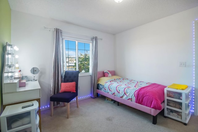 bedroom with carpet and a textured ceiling