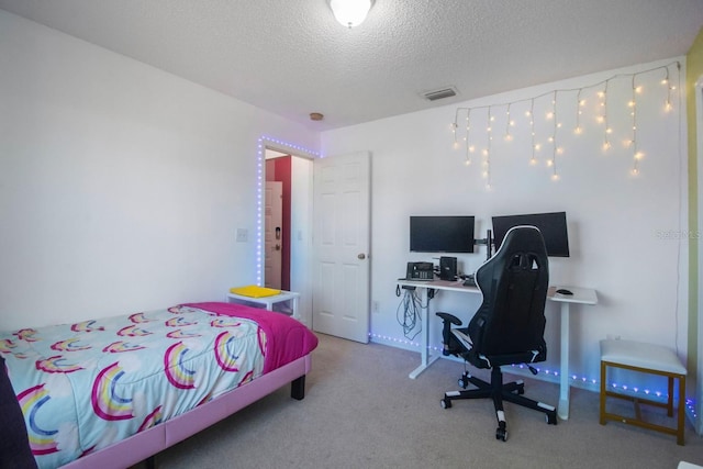 carpeted bedroom featuring a textured ceiling