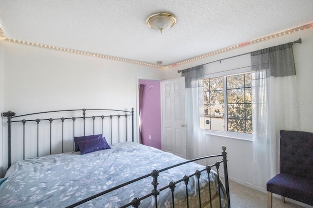 bedroom featuring carpet floors and a textured ceiling