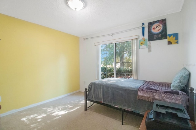 bedroom featuring carpet flooring and a textured ceiling