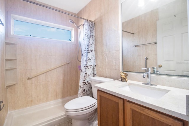 bathroom featuring curtained shower, vanity, and toilet