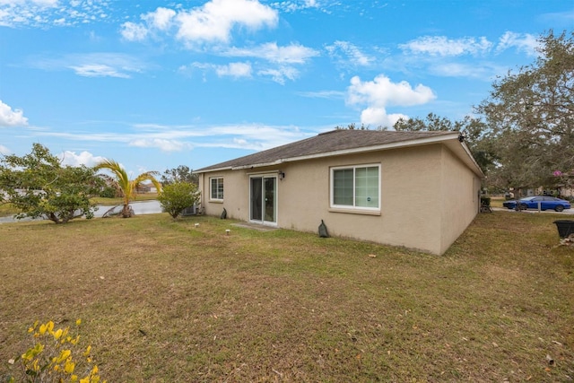 rear view of property with a yard