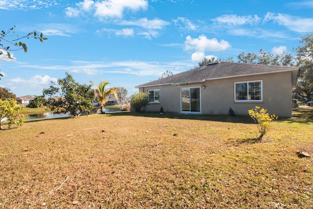 rear view of house with a yard