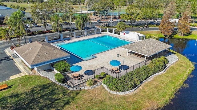 view of pool featuring a patio and a water view