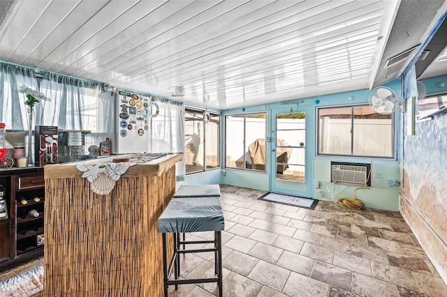 sunroom / solarium featuring vaulted ceiling