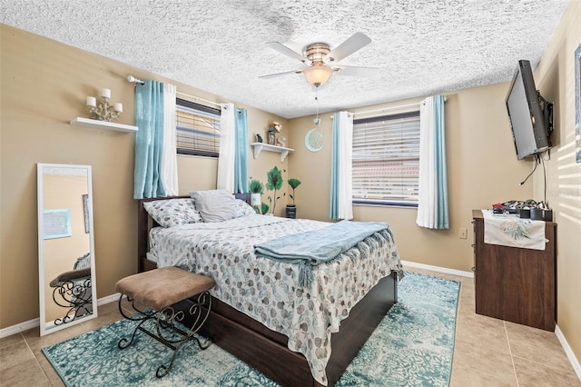 tiled bedroom with ceiling fan and a textured ceiling