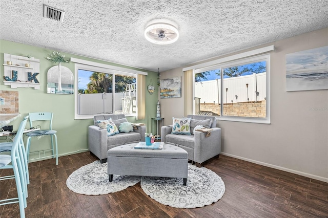 living room featuring a textured ceiling and dark hardwood / wood-style floors