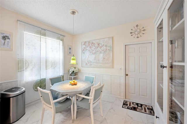 dining room featuring a textured ceiling