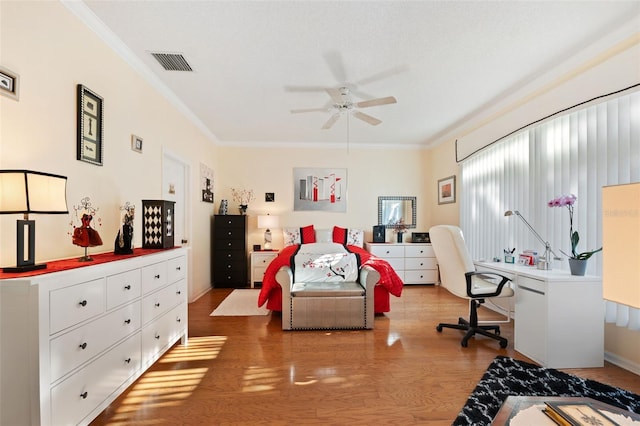 bedroom featuring crown molding, wood-type flooring, a textured ceiling, and ceiling fan