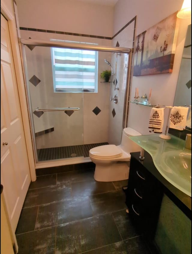 bathroom with vanity, toilet, and an enclosed shower