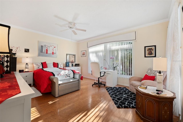 bedroom featuring ceiling fan, ornamental molding, and hardwood / wood-style floors