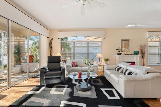 living room with hardwood / wood-style floors, plenty of natural light, and a textured ceiling