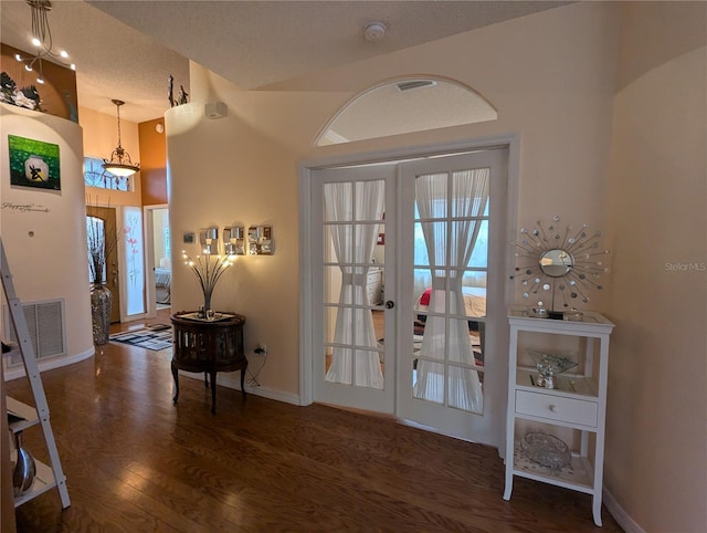 entrance foyer with dark hardwood / wood-style floors and french doors