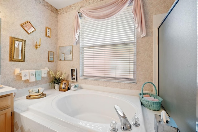 bathroom with vanity, separate shower and tub, and a healthy amount of sunlight