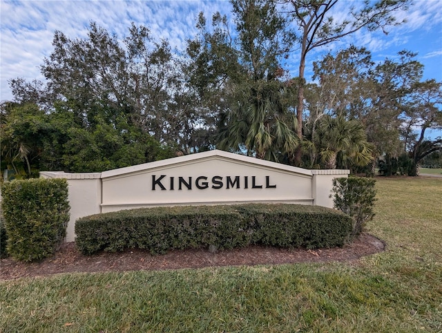 community sign featuring a lawn