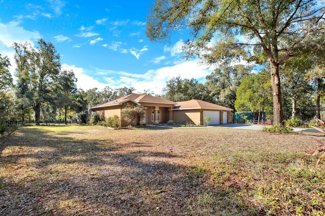 view of property exterior featuring a lawn and a garage