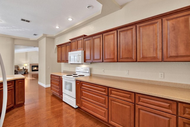 kitchen featuring white appliances and hardwood / wood-style flooring