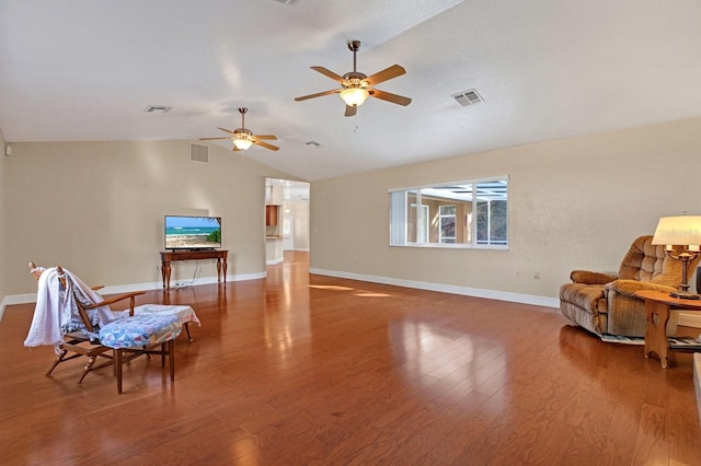 sitting room with ceiling fan, hardwood / wood-style floors, and lofted ceiling