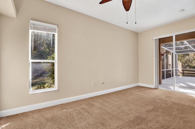 unfurnished room featuring carpet floors and ceiling fan