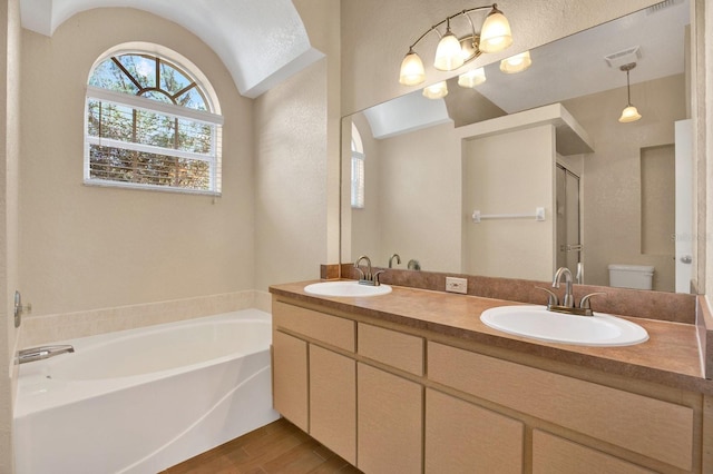 full bathroom with lofted ceiling, hardwood / wood-style floors, toilet, separate shower and tub, and vanity