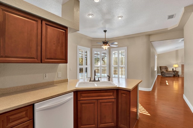 kitchen featuring dishwasher, kitchen peninsula, ceiling fan, a textured ceiling, and sink