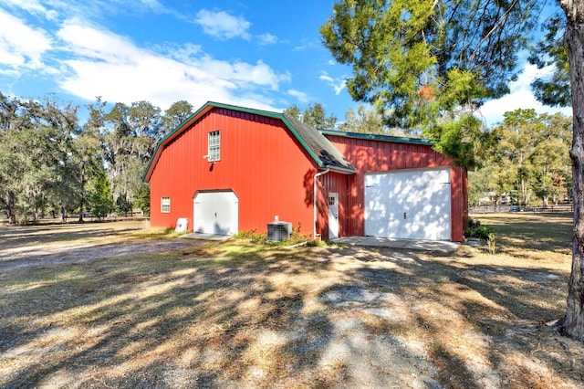 view of outdoor structure featuring central AC and a garage