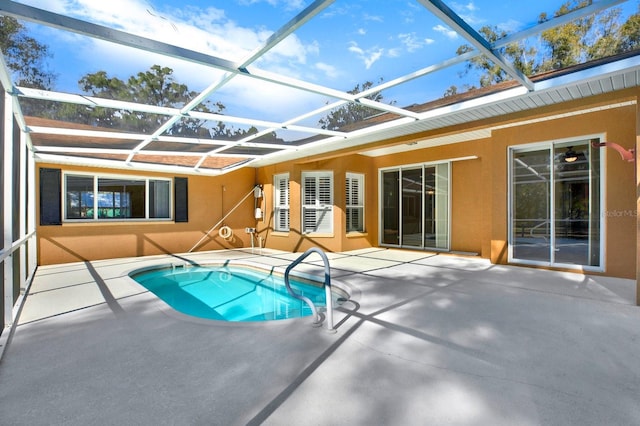 view of swimming pool featuring a lanai and a patio area