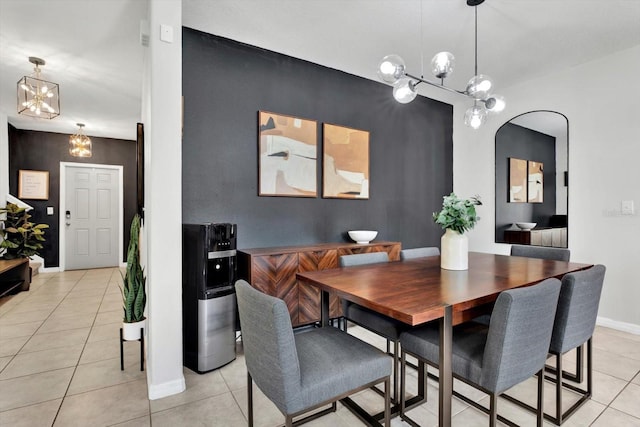 dining space with light tile patterned flooring and an inviting chandelier